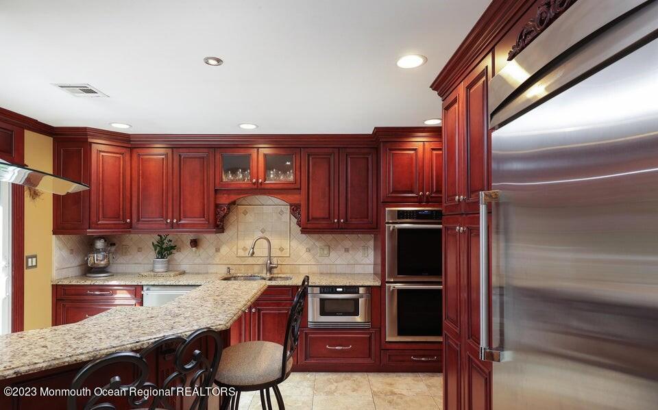 245 Delaware Trail Jackson, NJ 08527 - Photo 11 of 43 a kitchen with granite countertop a refrigerator stove and sink