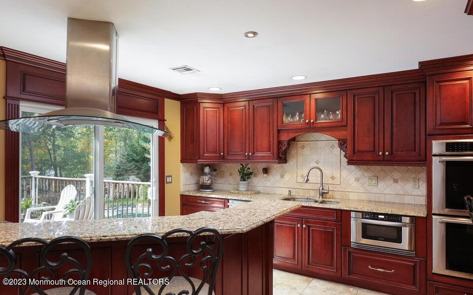 245 Delaware Trail Jackson, NJ 08527 - Photo 12 of 43 a kitchen with granite countertop a stove a sink and a microwave