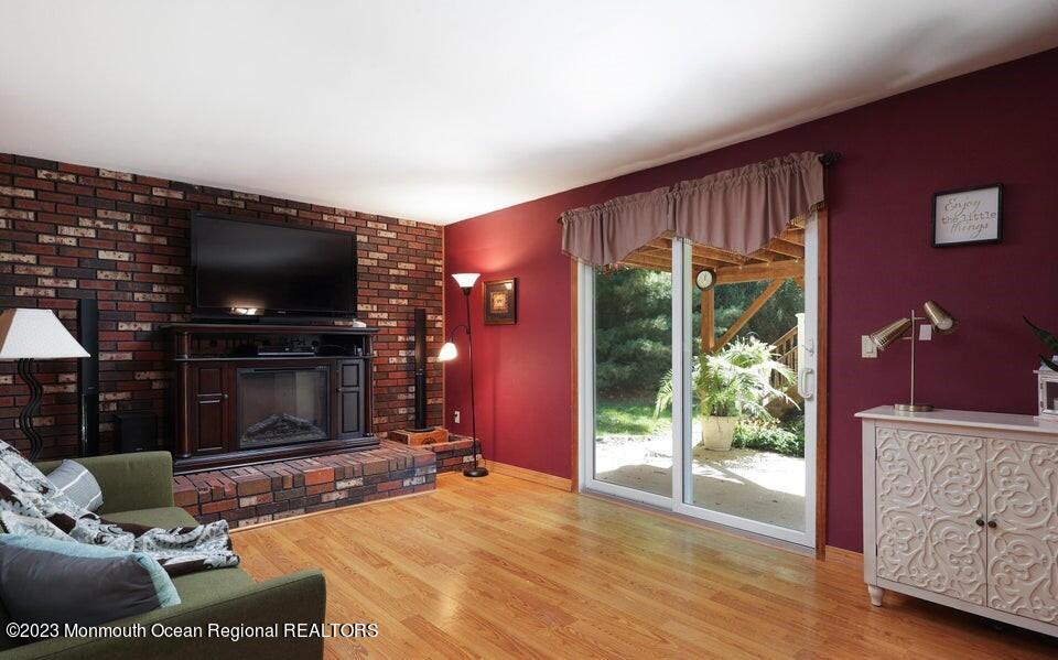 245 Delaware Trail Jackson, NJ 08527 - Photo 17 of 43 a living room with furniture a flat screen tv and a fireplace