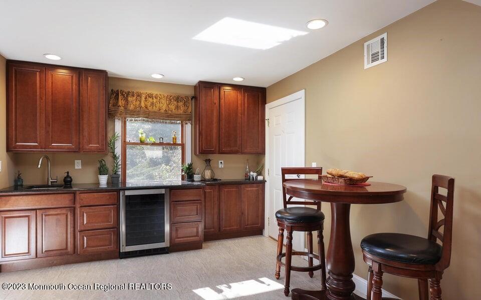 245 Delaware Trail Jackson, NJ 08527 - Photo 20 of 43 a kitchen with a sink a stove and chairs