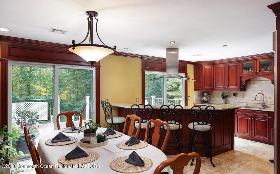 245 Delaware Trail Jackson, NJ 08527 - Photo 9 of 43 a kitchen with stainless steel appliances granite countertop a stove a sink dishwasher and a dining table with garden view