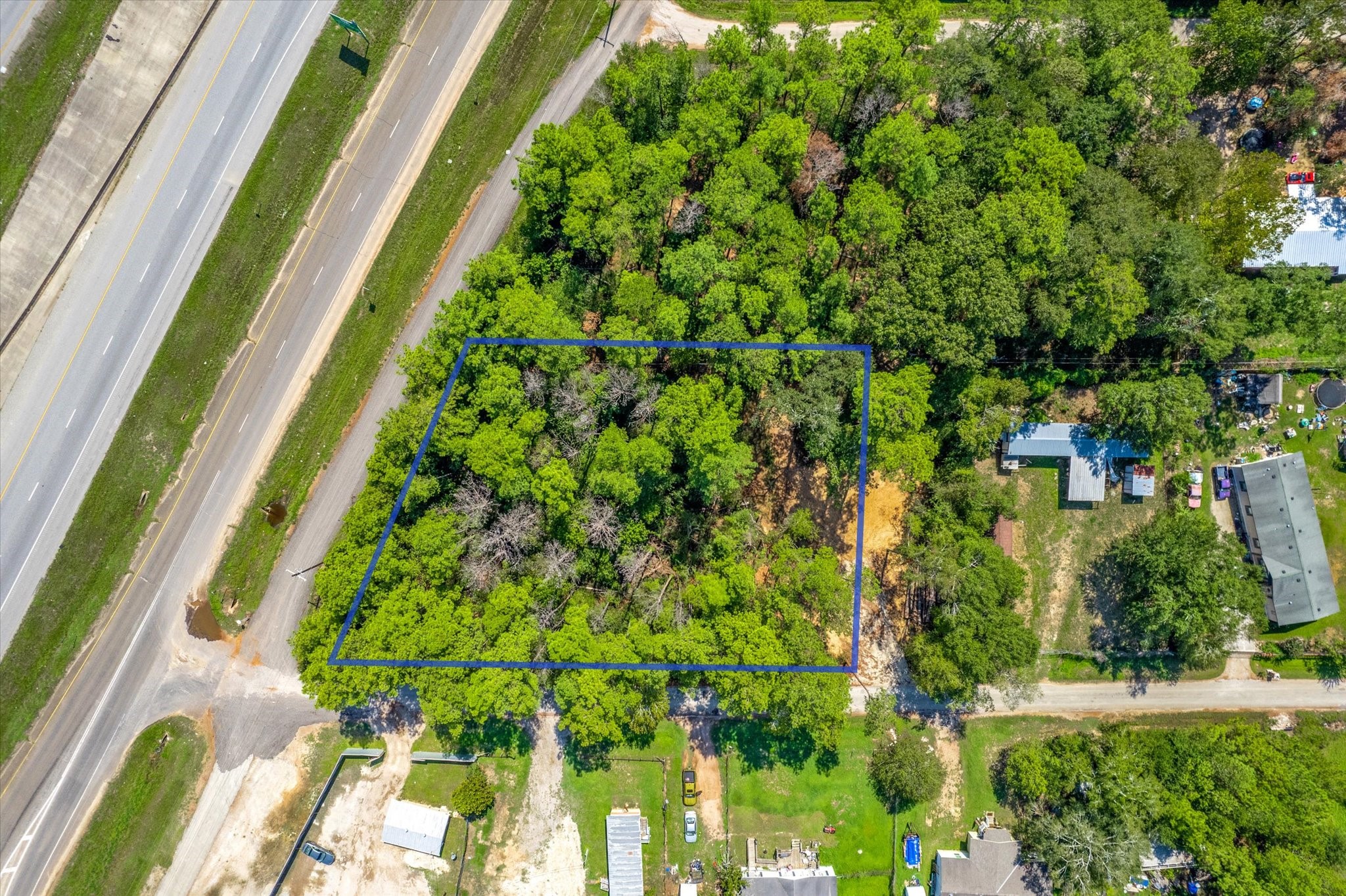 0 Highway 59 Cleveland, TX 77328 - Photo 8 of 12 a backyard of a house with lots of green space and garden in the back