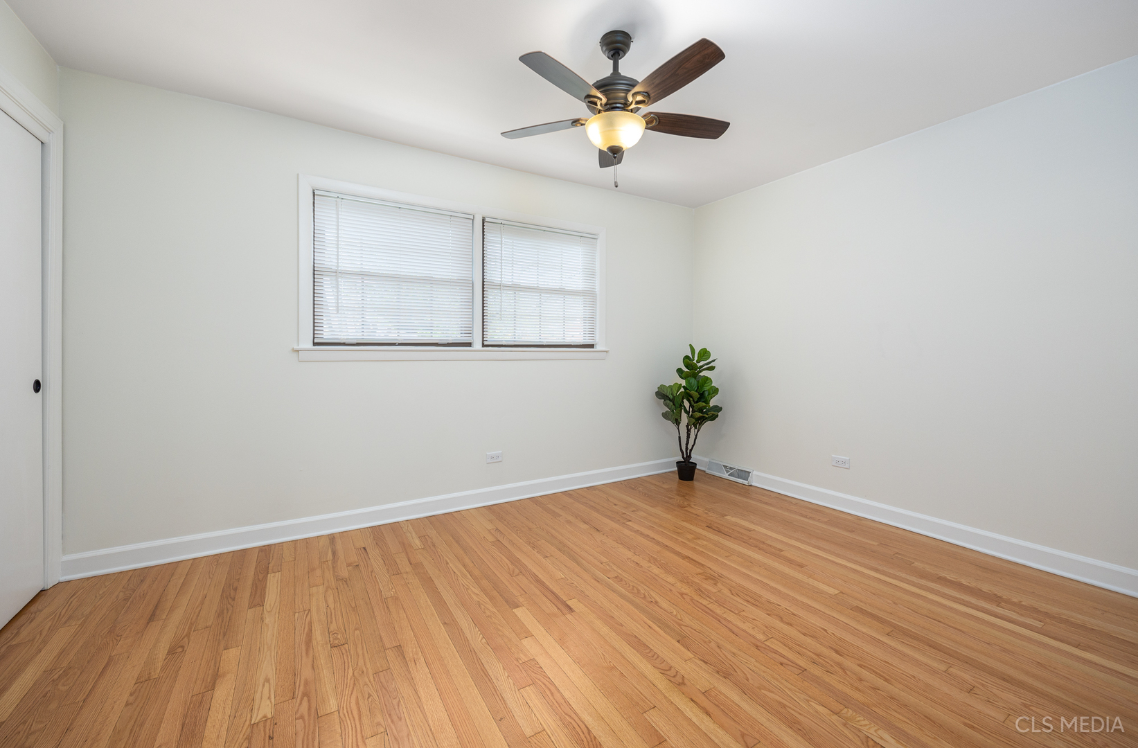 2112 Oakton Street Park Ridge, IL 60068 - Photo 13 of 24 a view of an empty room with wooden floor and a window