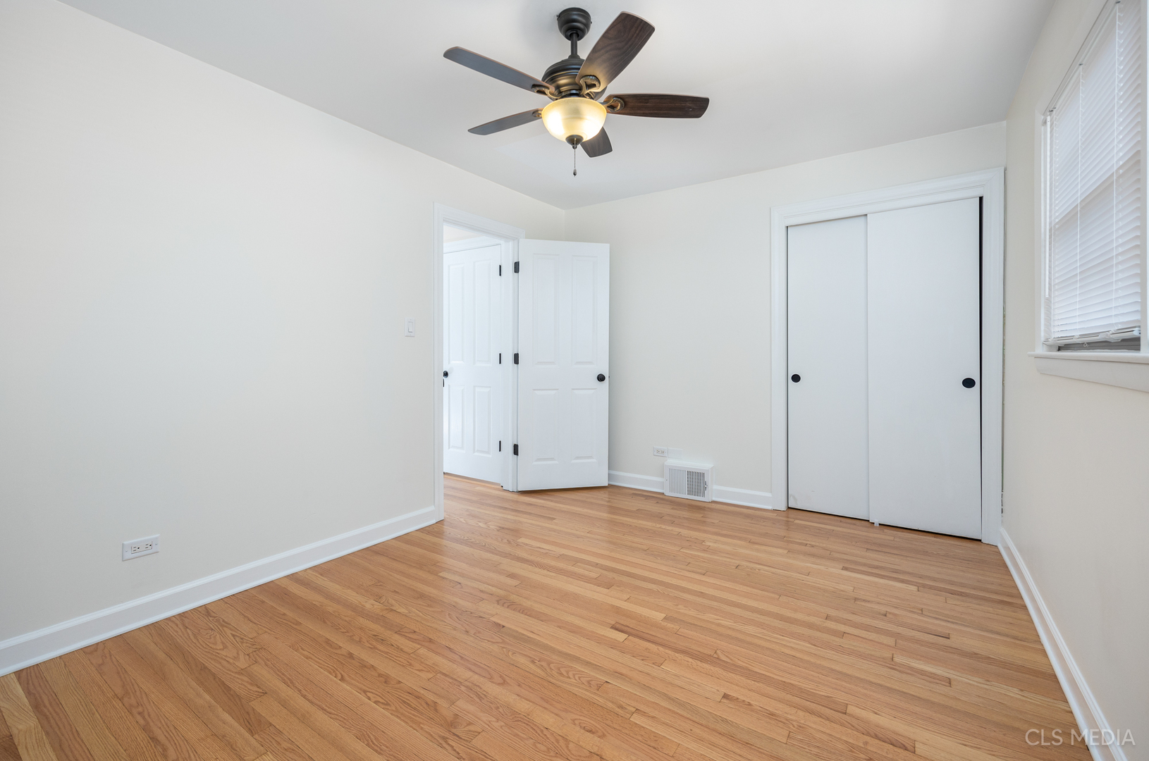 2112 Oakton Street Park Ridge, IL 60068 - Photo 14 of 24 a view of a room with wooden floor and a ceiling fan
