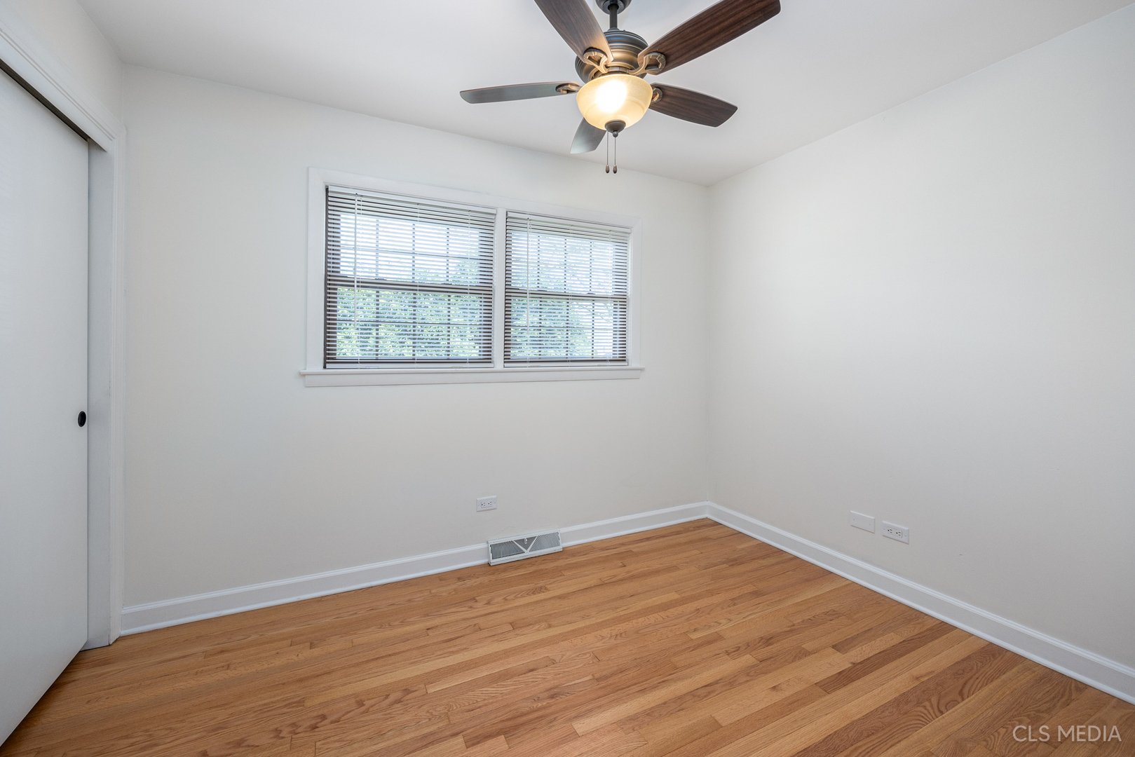 2112 Oakton Street Park Ridge, IL 60068 - Photo 15 of 24 wooden floor in an empty room with a window