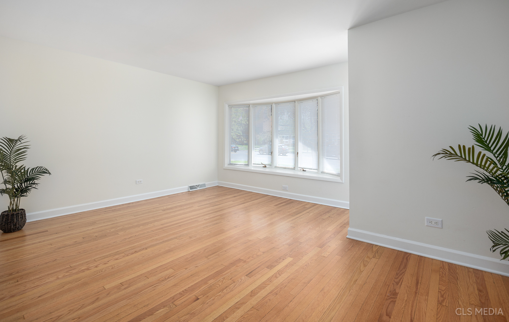 2112 Oakton Street Park Ridge, IL 60068 - Photo 4 of 24 an empty room with wooden floor and windows
