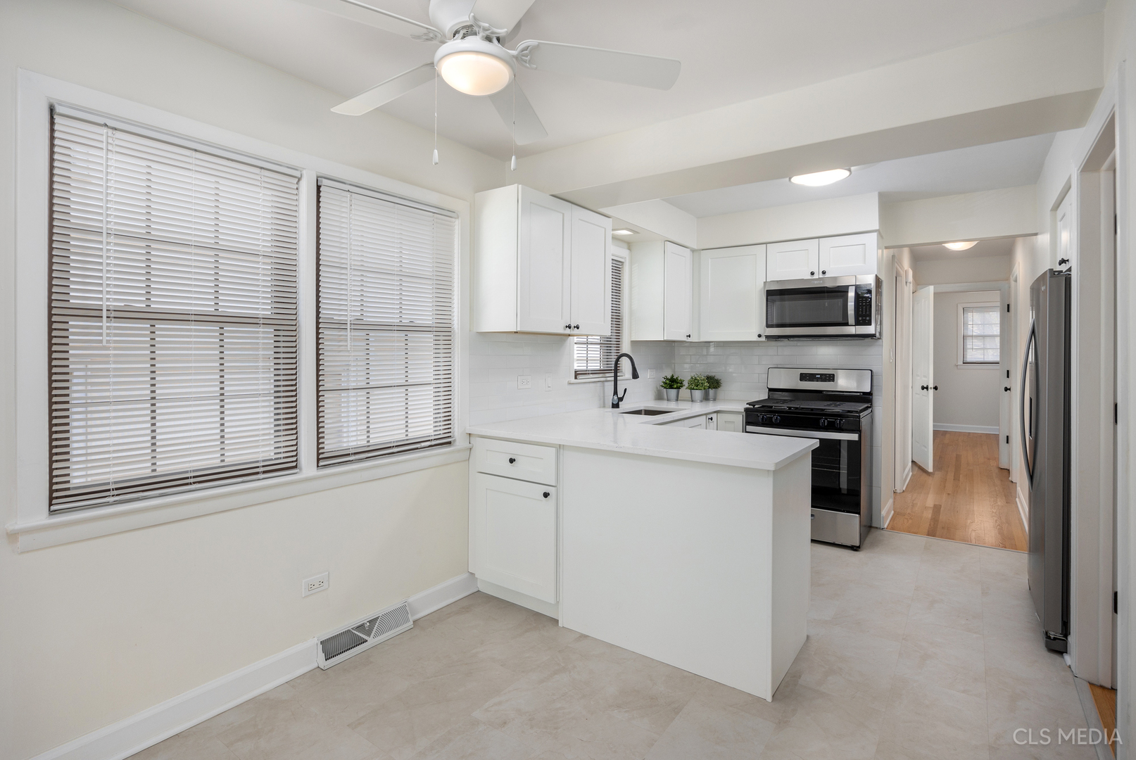 2112 Oakton Street Park Ridge, IL 60068 - Photo 6 of 24 a kitchen with a refrigerator a sink and a stove top oven