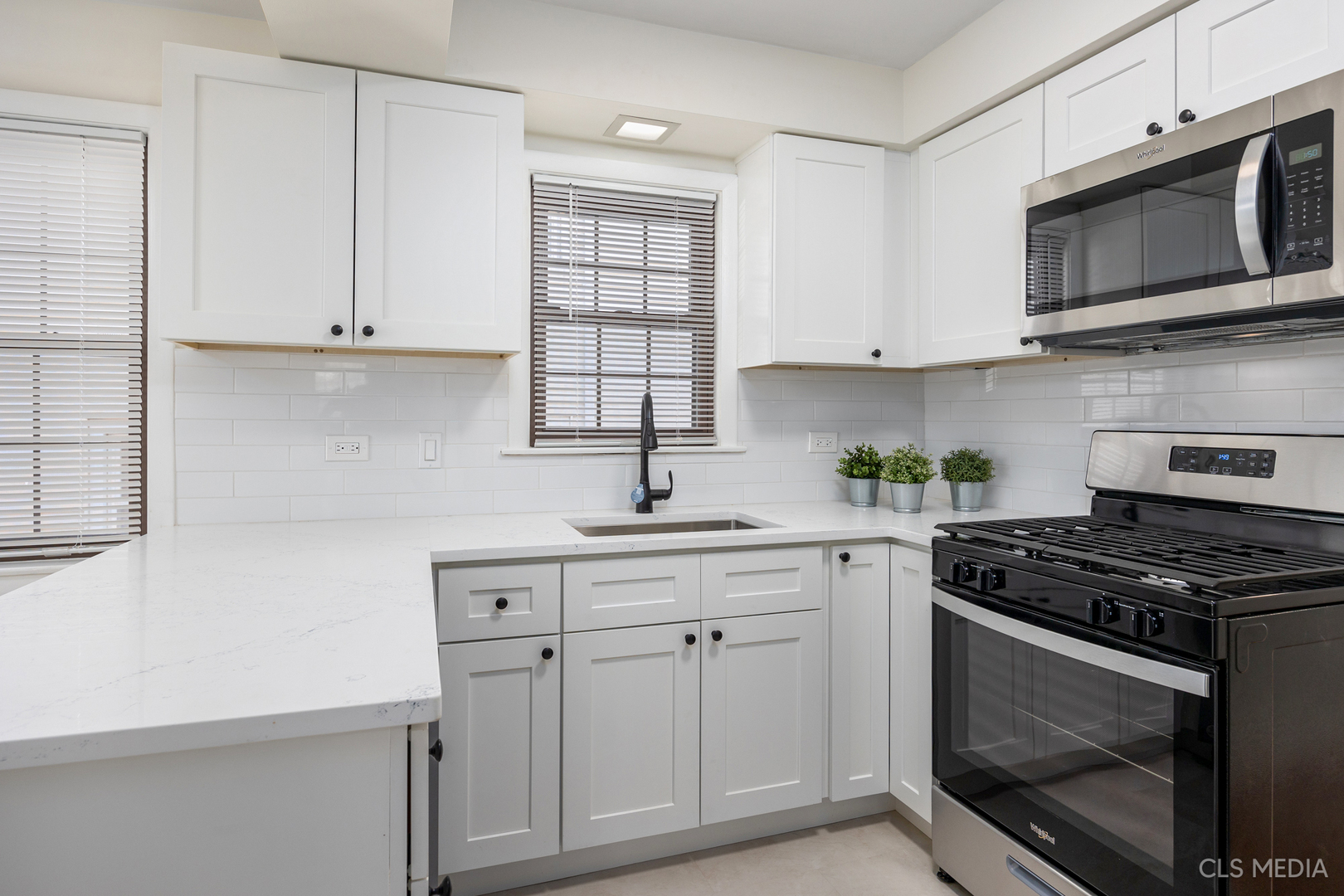 2112 Oakton Street Park Ridge, IL 60068 - Photo 7 of 24 a kitchen with white cabinets and appliances