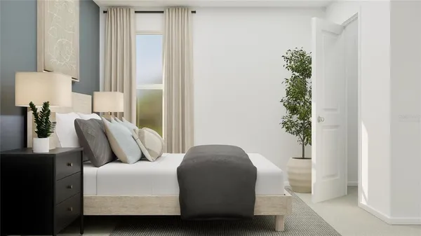 a bedroom with furniture and a potted plant