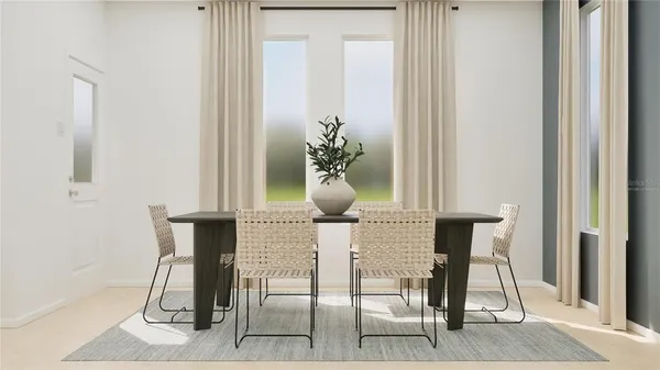 a dining room with furniture and a potted plant