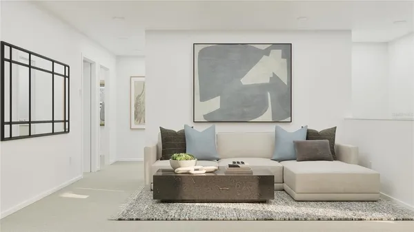 a living room with furniture and a painting on the wall