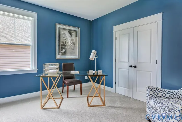 a view of a workspace with furniture and a window