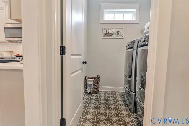 a walk in closet with wooden floor