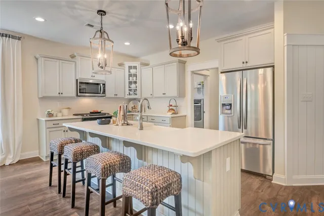 a large kitchen with a table and chairs