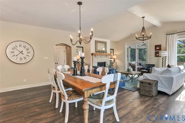 a view of a dining room with furniture a chandelier and wooden floor