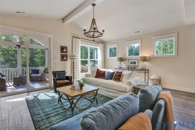 a living room with furniture a large window and a table