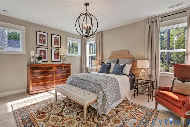 a bed room with a bed and a chair