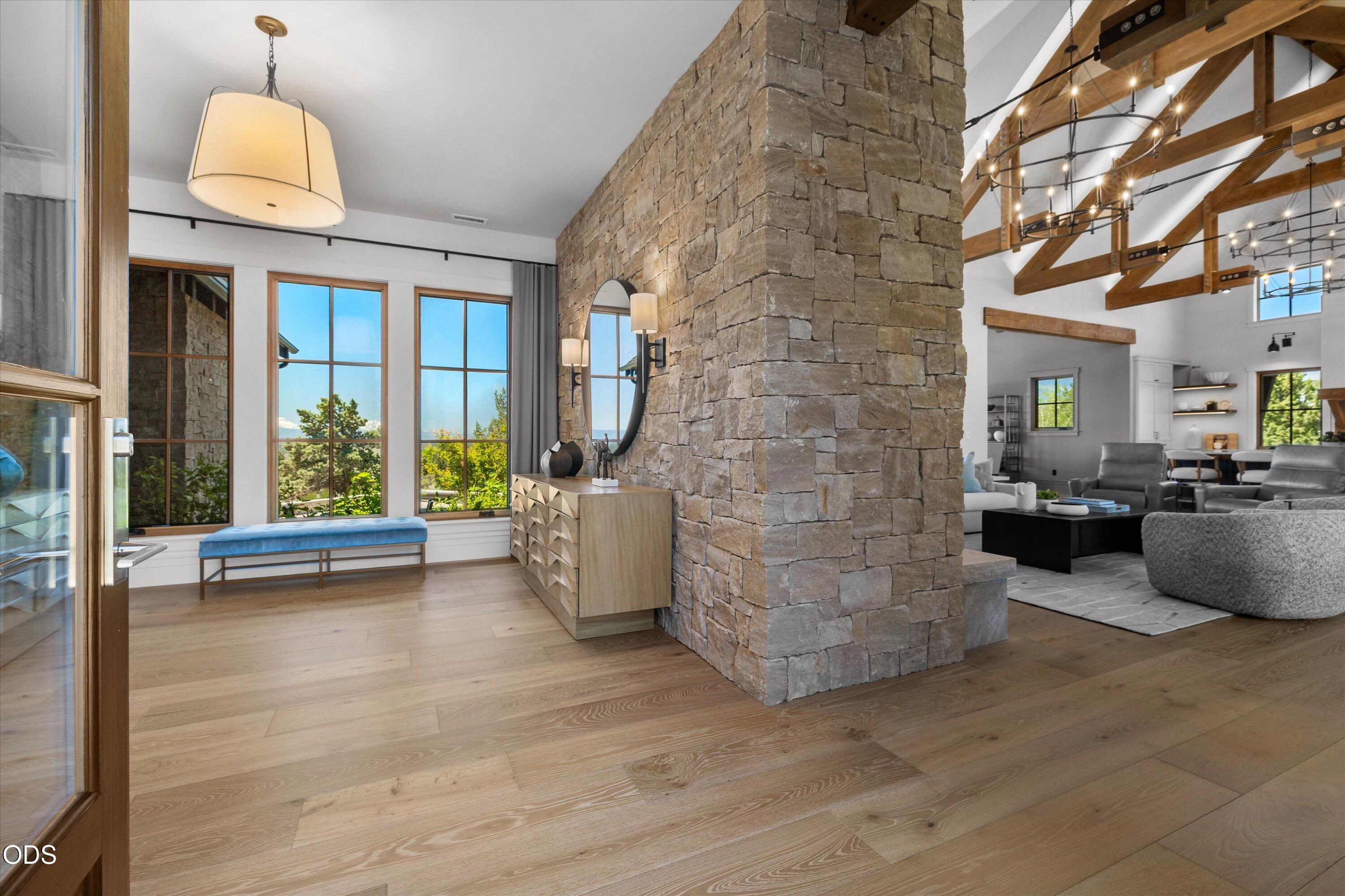 16215 South W Vaqueros Way Powell Butte, OR 97753 - Photo 6 of 48 A warm entry to the home features an oversized foyer with statement stone, views of the Cascade mountains, connecting the primary bedroom and lockable guest suites to the living areas