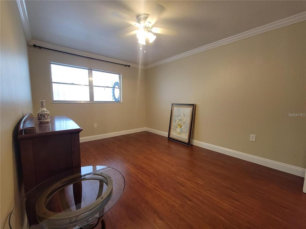 911 Washington Avenue Southwest, Unit 308 Largo, FL 33770 - Photo 14 of 24 a room with wooden floor and a window