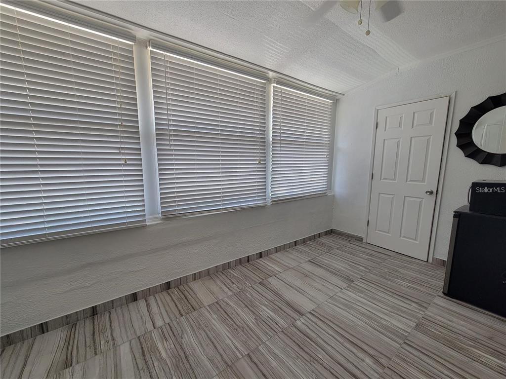911 Washington Avenue Southwest, Unit 308 Largo, FL 33770 - Photo 19 of 24 a view of an empty room with a window and wooden floor