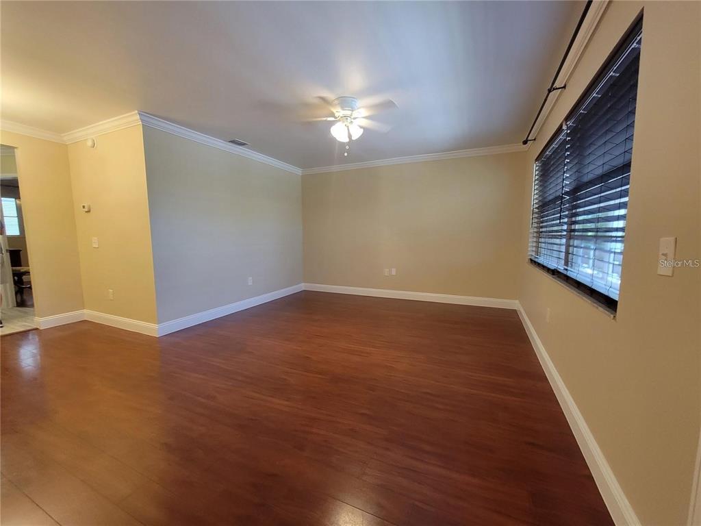 911 Washington Avenue Southwest, Unit 308 Largo, FL 33770 - Photo 2 of 24 wooden floor in an empty room with a window
