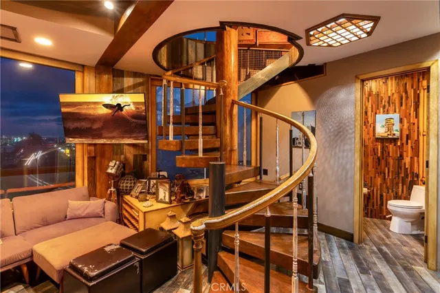 a view of a dining room with furniture a chandelier and wooden floor