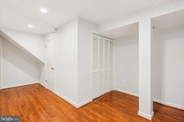 a view of empty room with wooden floor