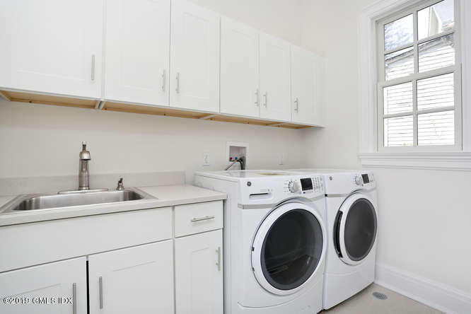 100 Lewis Street, Unit WEST Greenwich, CT 06830 - Photo 22 of 32 a utility room with sink dryer and washer