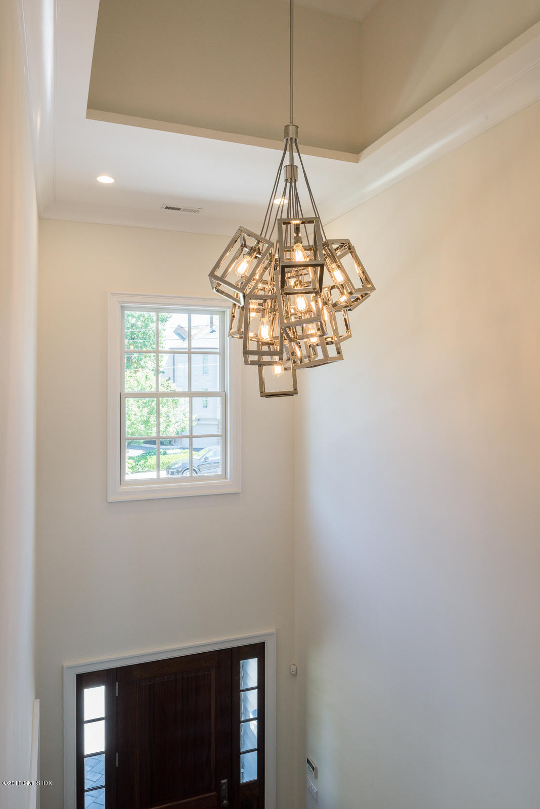 100 Lewis Street, Unit WEST Greenwich, CT 06830 - Photo 6 of 32 a room with a window and a chandelier
