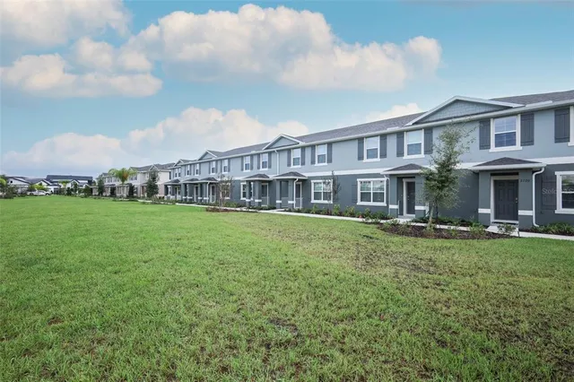 a view of an house with backyard and a garden