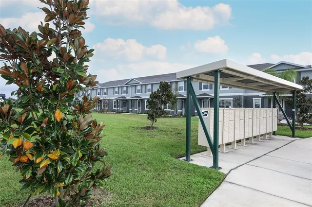 a view of a house with backyard and porch