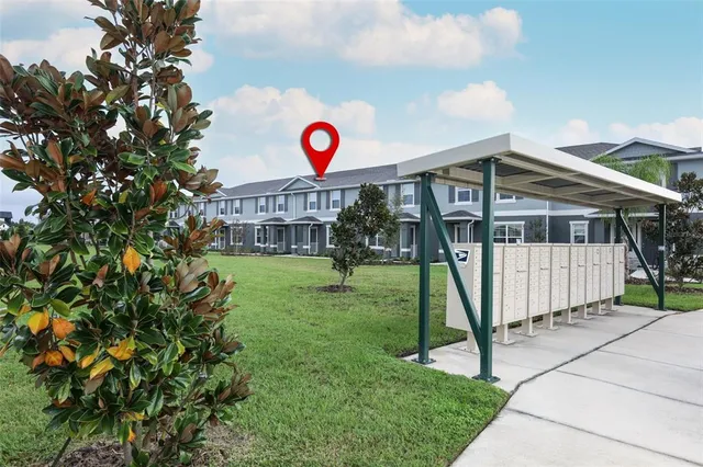 a view of a house with a backyard