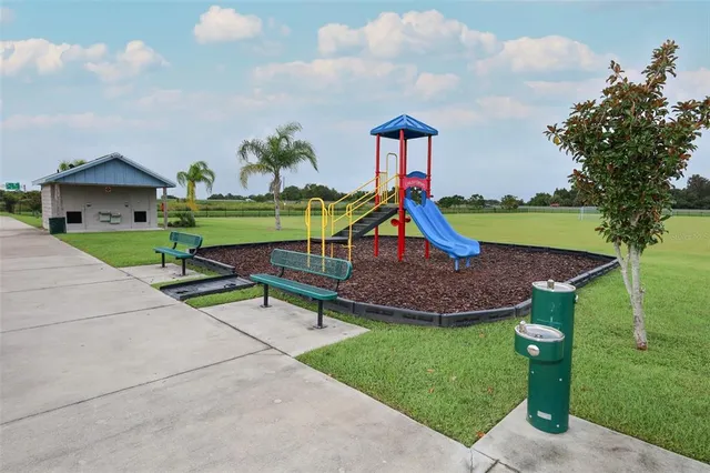 a view of outdoor space with playground and green space