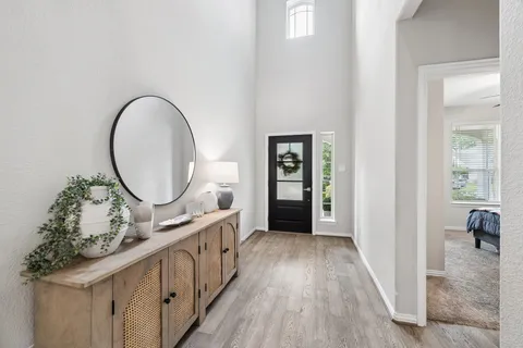 wooden floor with a mirror in a room