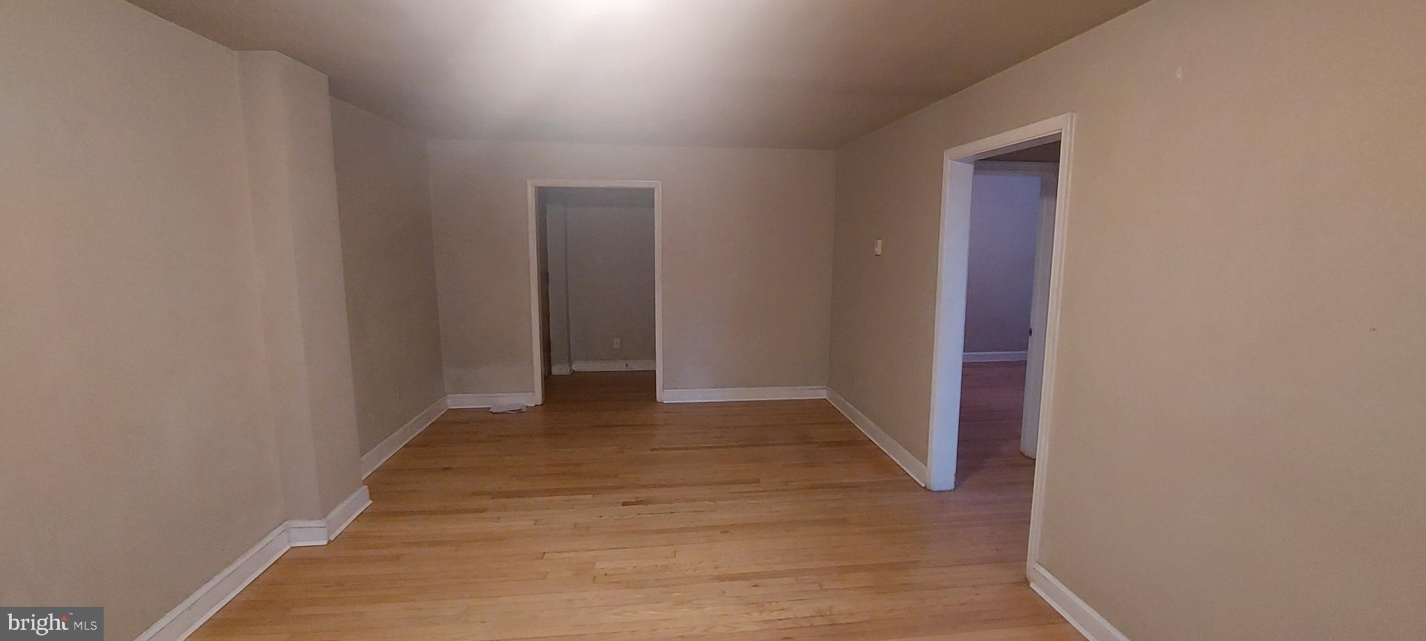 a view of hallway with wooden floor