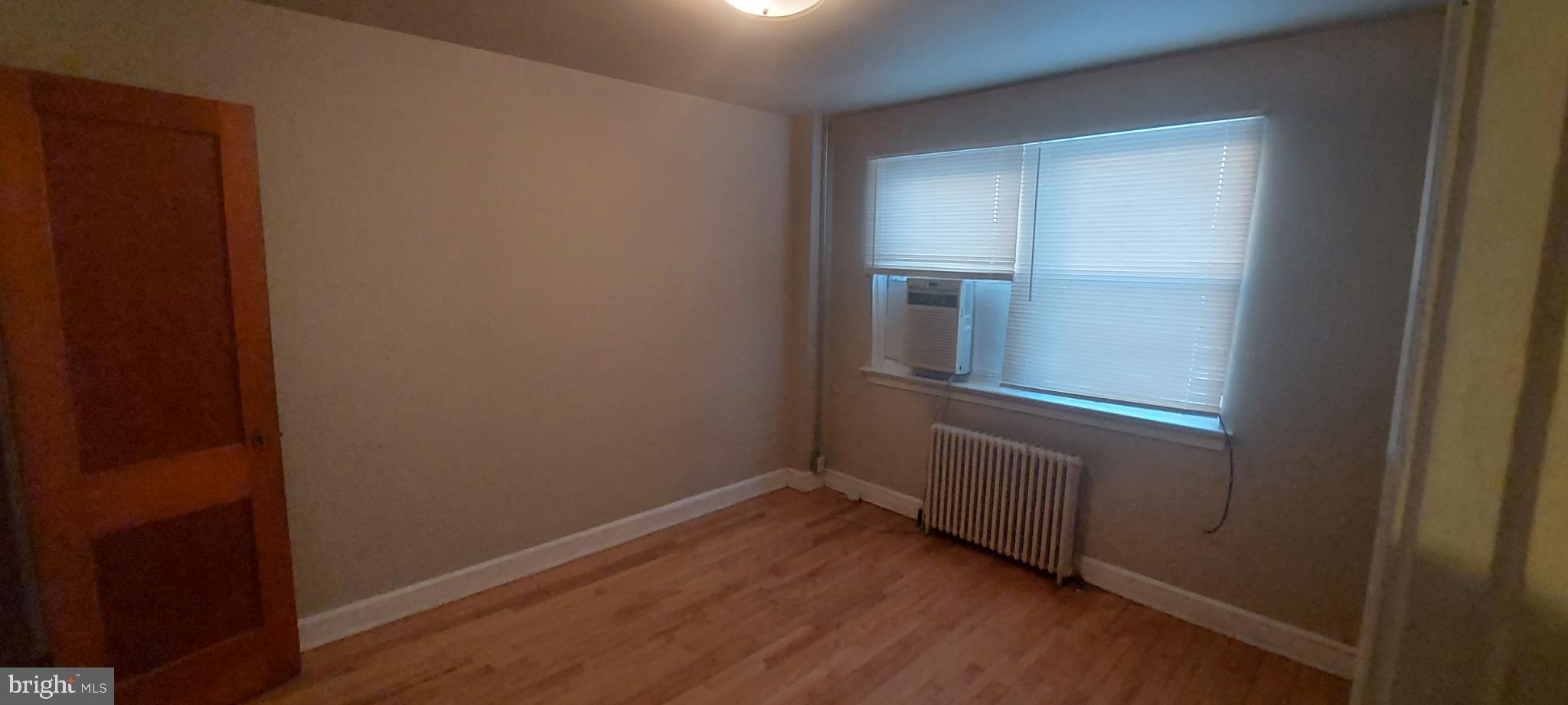 9863 Main Street, Unit 4 Damascus, MD 20872 - Photo 10 of 11 wooden floor and window in an empty room