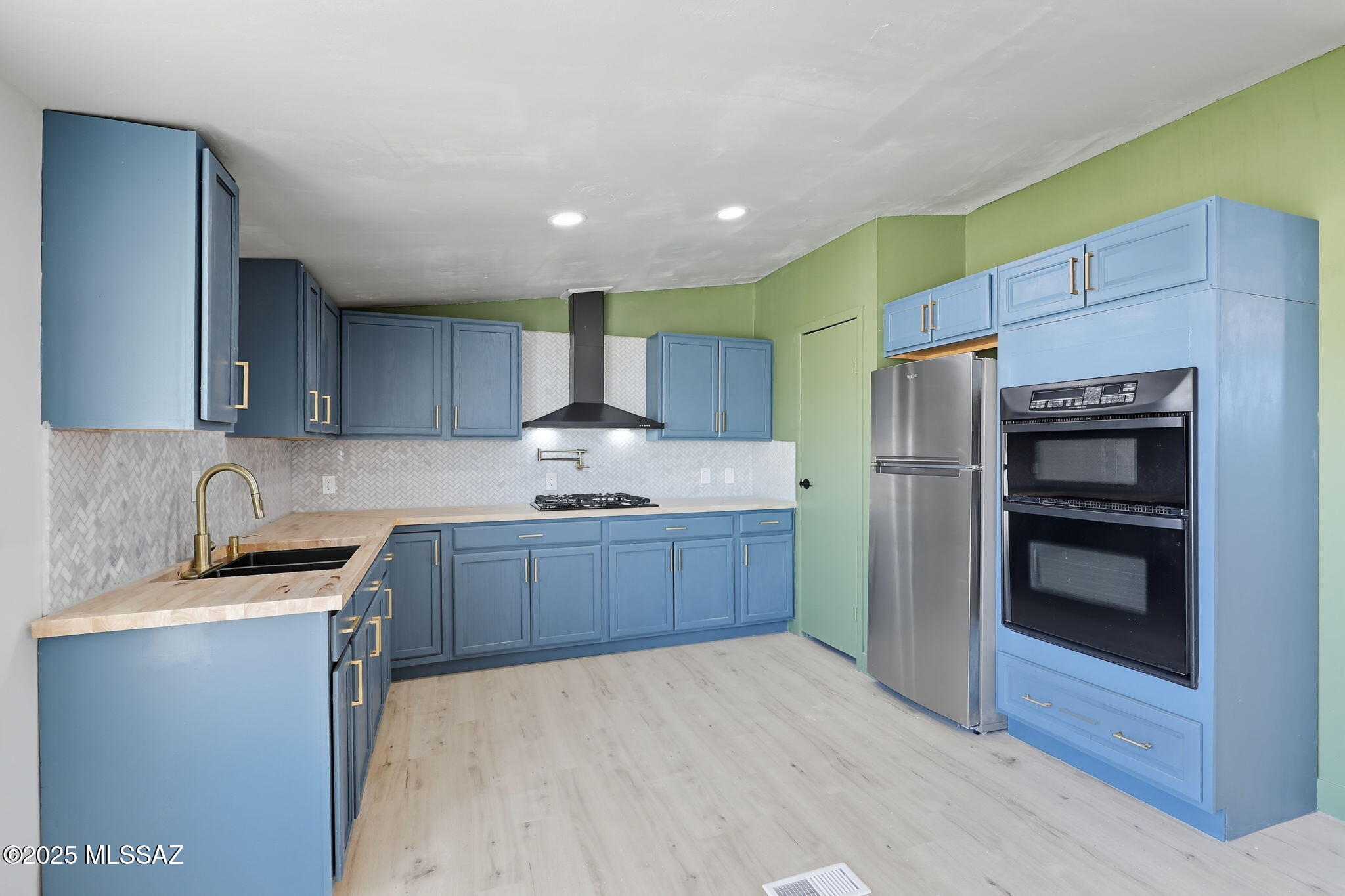 8790 North Trico Road Marana, AZ 85653 - Photo 8 of 35 a kitchen with granite countertop a refrigerator and a sink