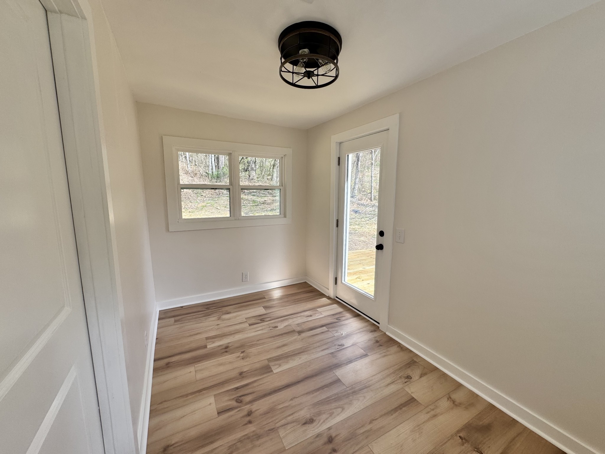 220 Friendship Hollow Road South Pleasant Shade, TN 37145 - Photo 25 of 50 an empty room with wooden floor and windows