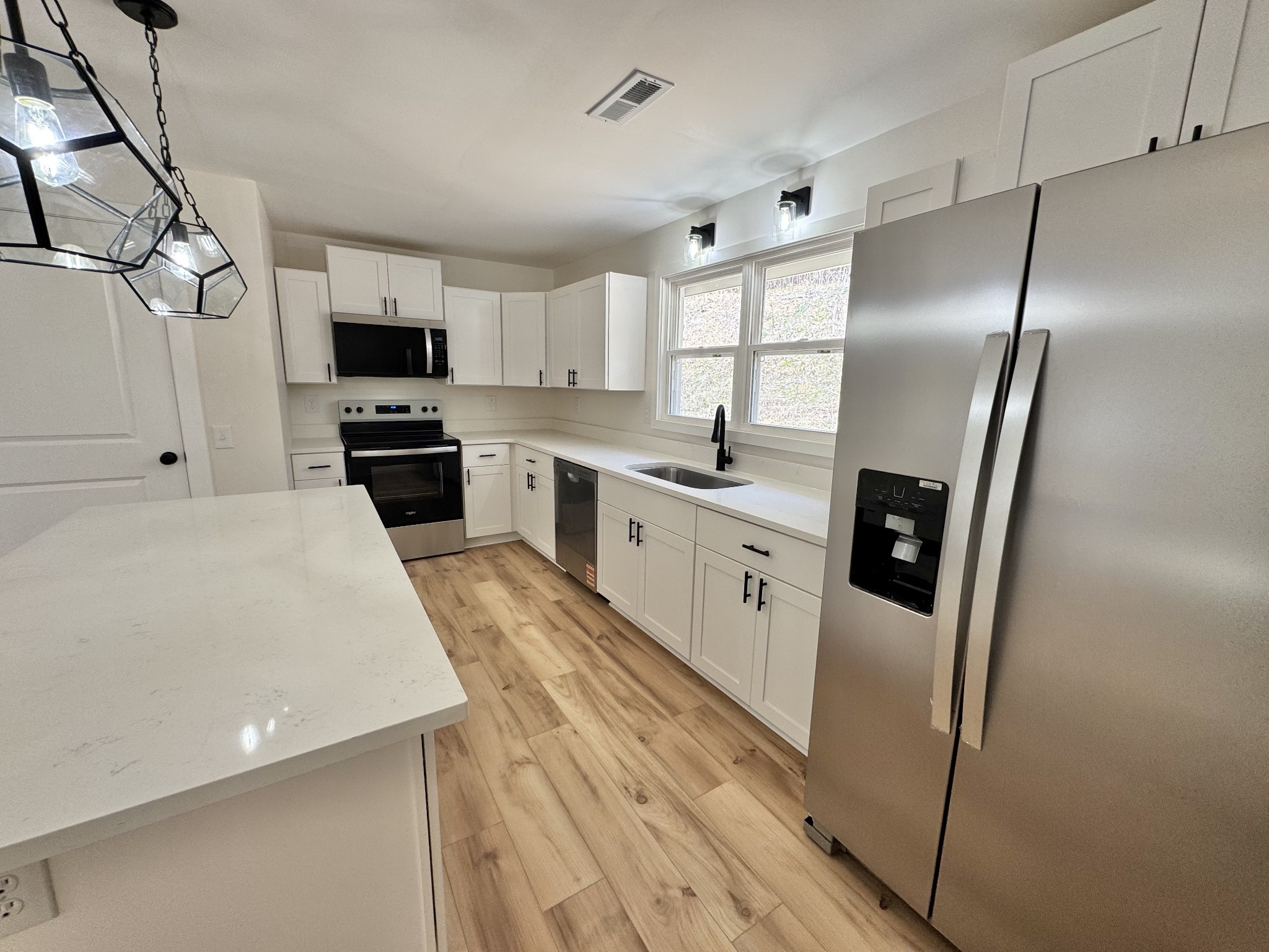 220 Friendship Hollow Road South Pleasant Shade, TN 37145 - Photo 6 of 50 a kitchen with stainless steel appliances a refrigerator sink and stove