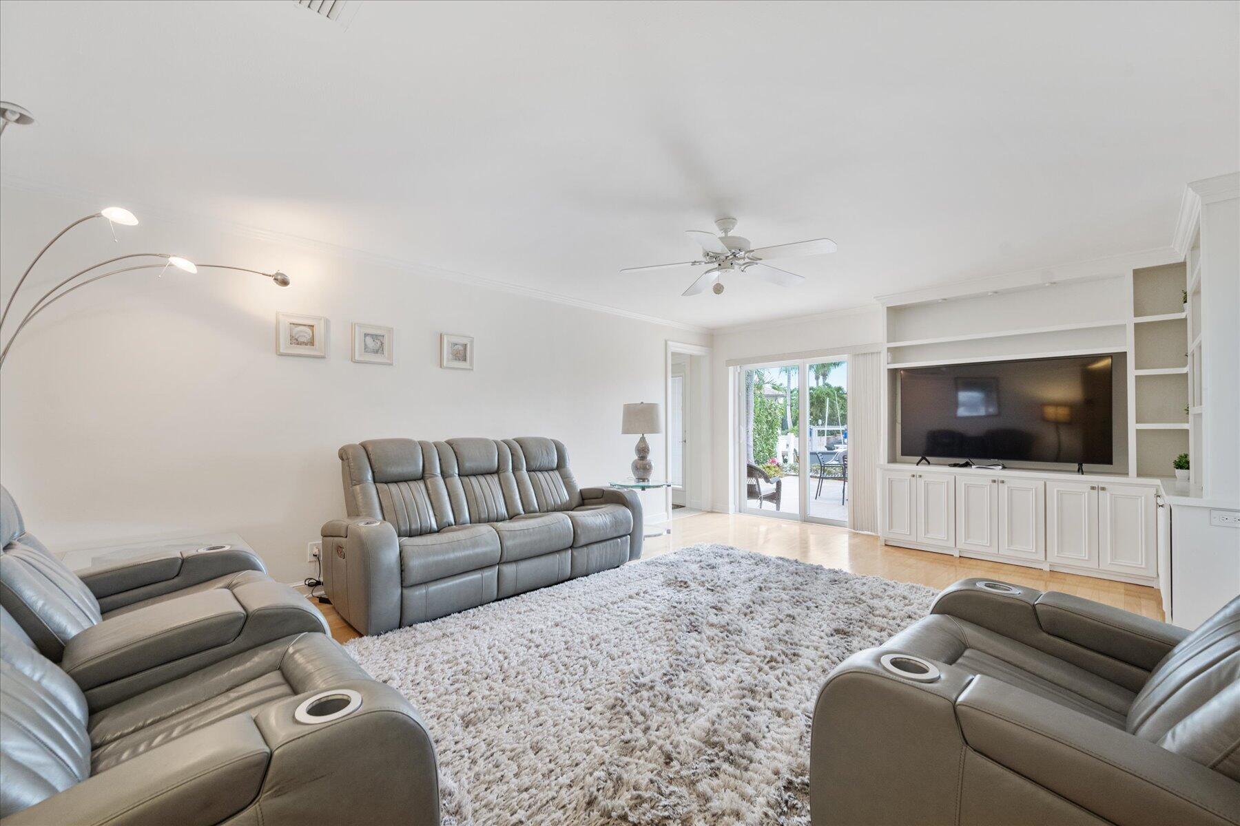 1180 Singer Drive Singer Island, FL 33404 - Photo 11 of 24 a living room with furniture and a flat screen tv