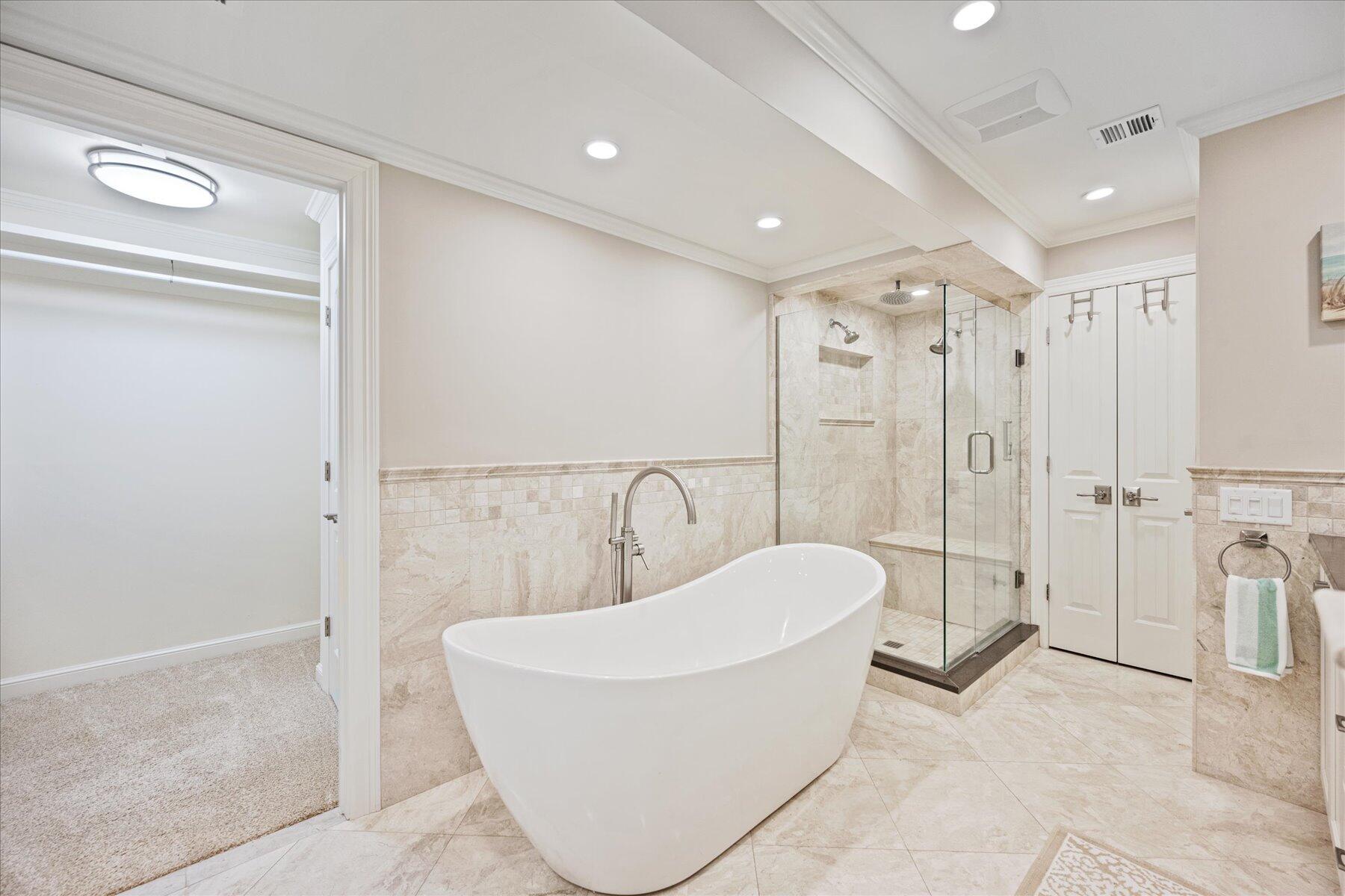 1180 Singer Drive Singer Island, FL 33404 - Photo 13 of 24 a bathroom with a bathtub and shower