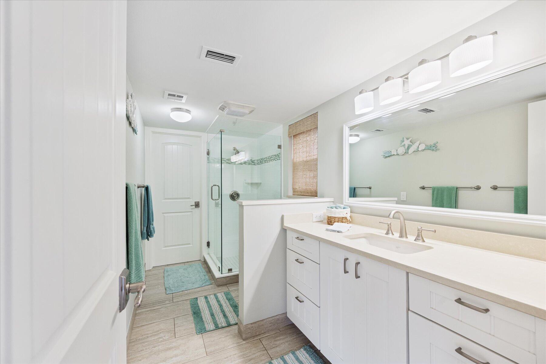 1180 Singer Drive Singer Island, FL 33404 - Photo 20 of 24 a spacious bathroom with a double vanity sink mirror and shower