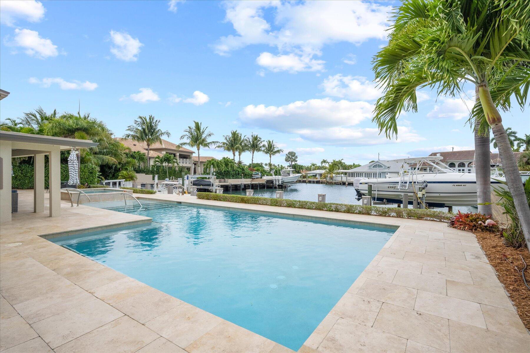1180 Singer Drive Singer Island, FL 33404 - Photo 22 of 24 a view of swimming pool with outdoor seating and plants