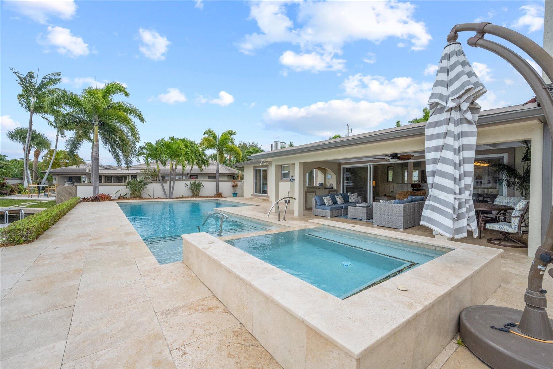 1180 Singer Drive Singer Island, FL 33404 - Photo 23 of 24 a view of house with swimming pool outdoor seating