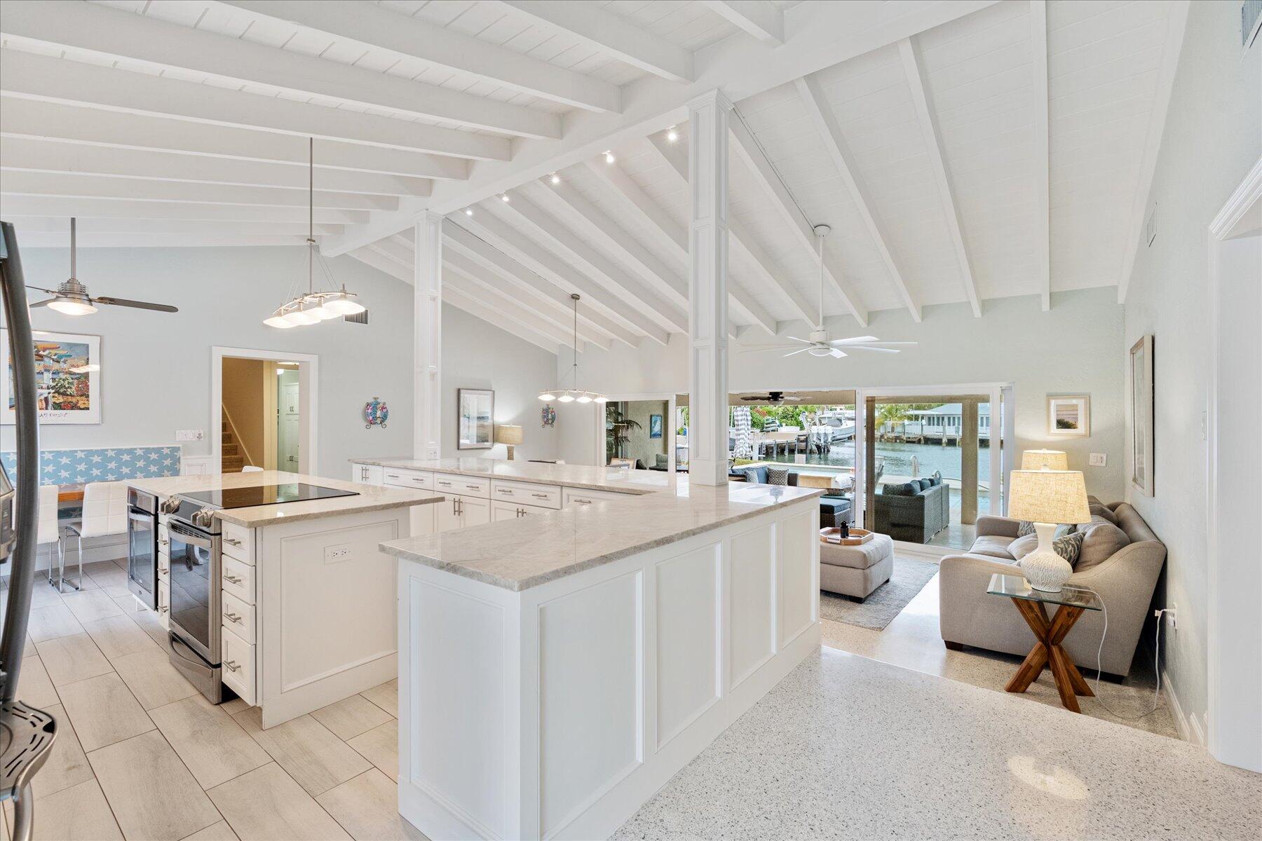 1180 Singer Drive Singer Island, FL 33404 - Photo 4 of 24 a kitchen with a sink stove and cabinets