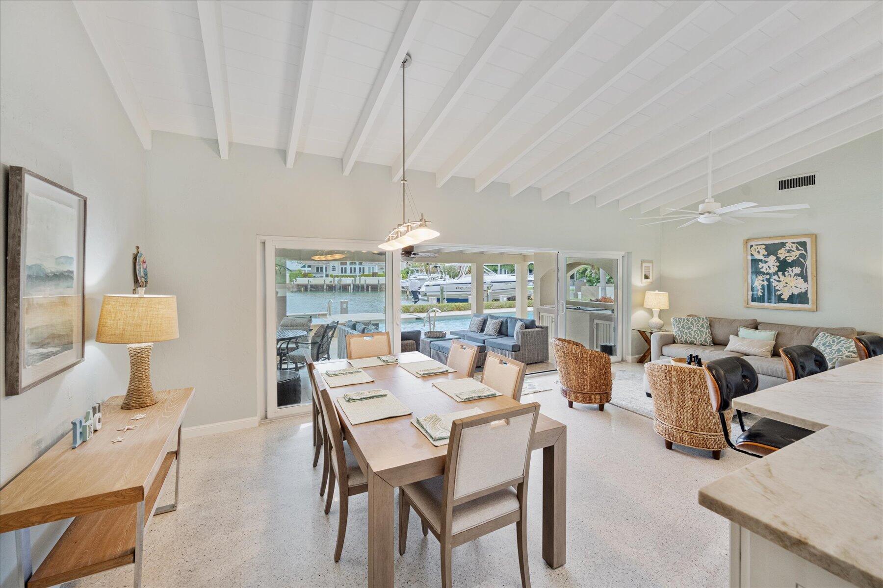 1180 Singer Drive Singer Island, FL 33404 - Photo 6 of 24 a view of a dining room with furniture window and outside view