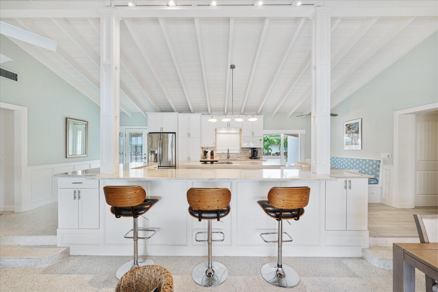 1180 Singer Drive Singer Island, FL 33404 - Photo 8 of 24 a kitchen with lots of counter space furniture and kitchen view