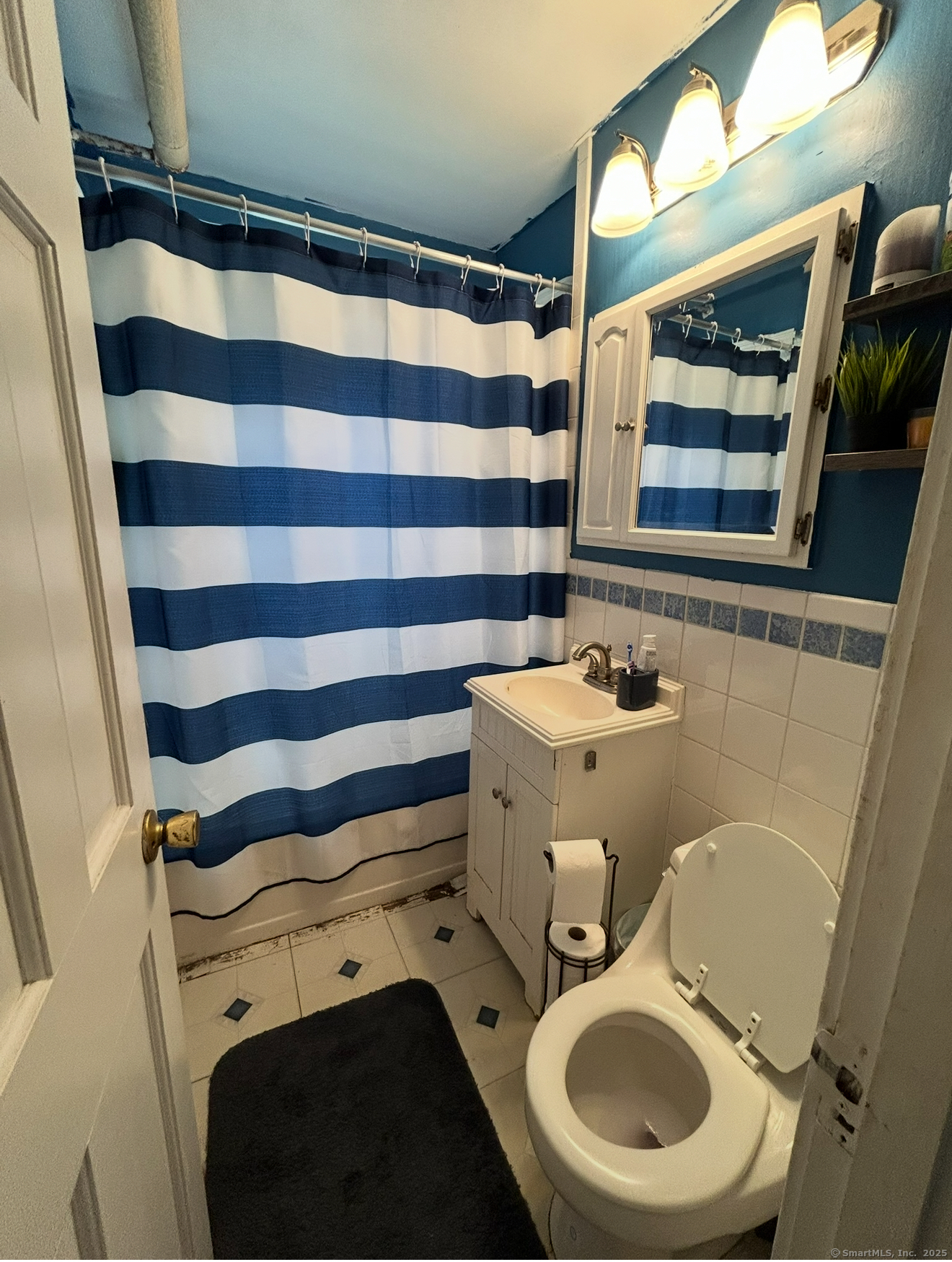 744 Canaan Road, Unit 23 Bridgeport, CT 06610 - Photo 13 of 14 a bathroom with a sink and a mirror