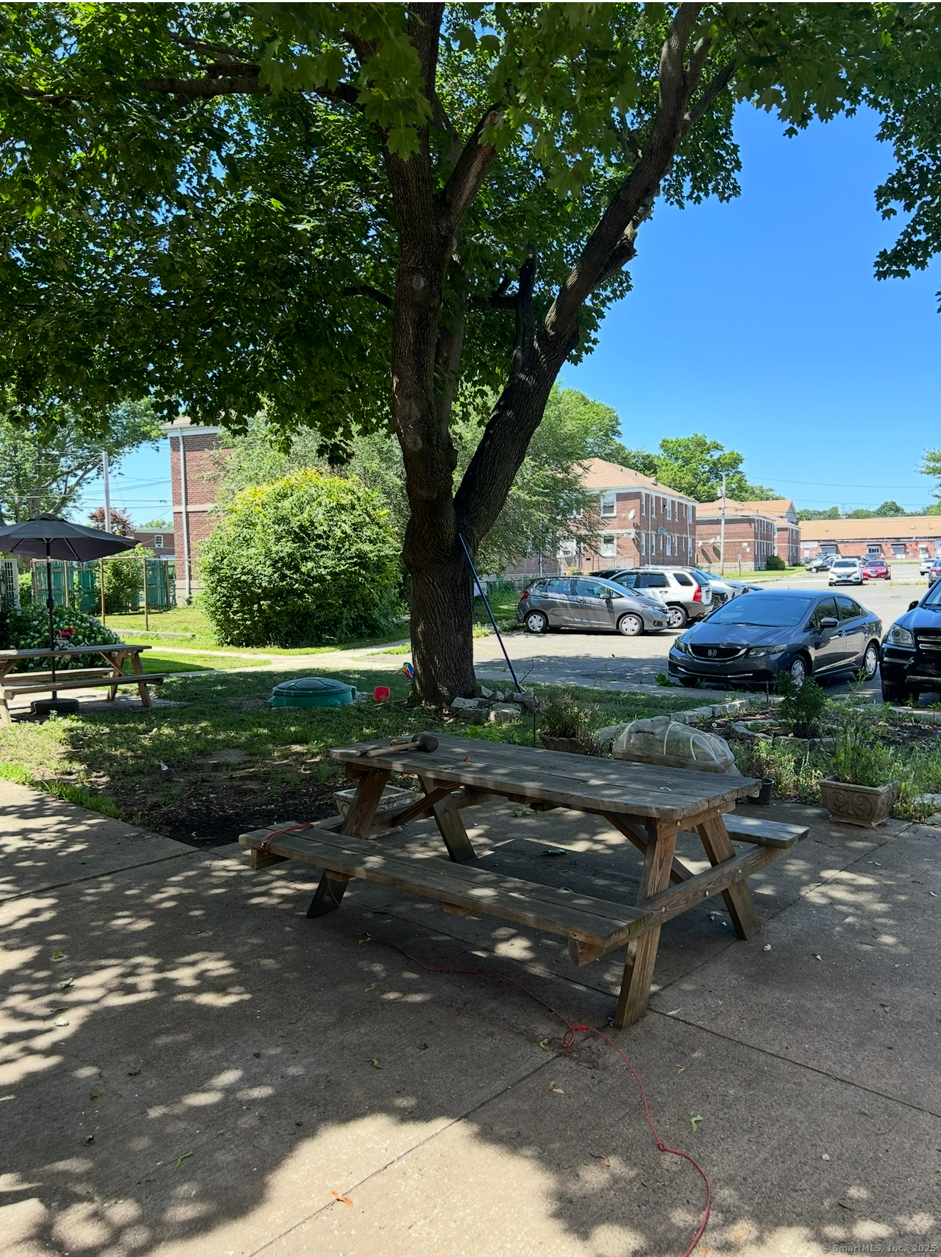 744 Canaan Road, Unit 23 Bridgeport, CT 06610 - Photo 14 of 14 a backyard of a house with lots of green space and fountain