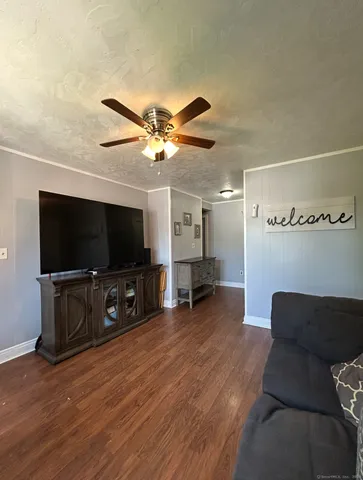 a view of a livingroom with furniture and a flat screen tv